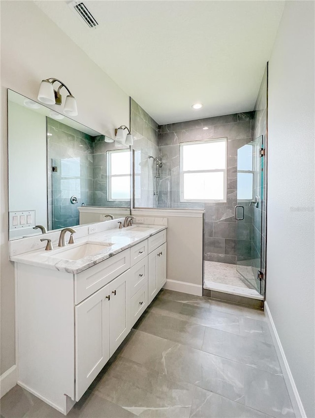 bathroom featuring vanity, an enclosed shower, and tile patterned floors