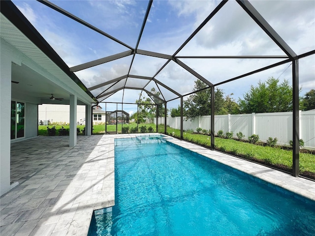 view of pool with a lanai, ceiling fan, and a patio area