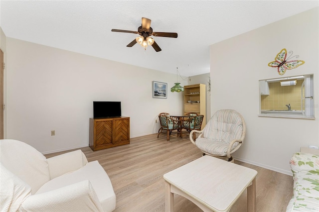 3 Quails Run Blvd Unit 8, Englewood, FL 34223 - living area with baseboards, a ceiling fan, and light wood-style floors