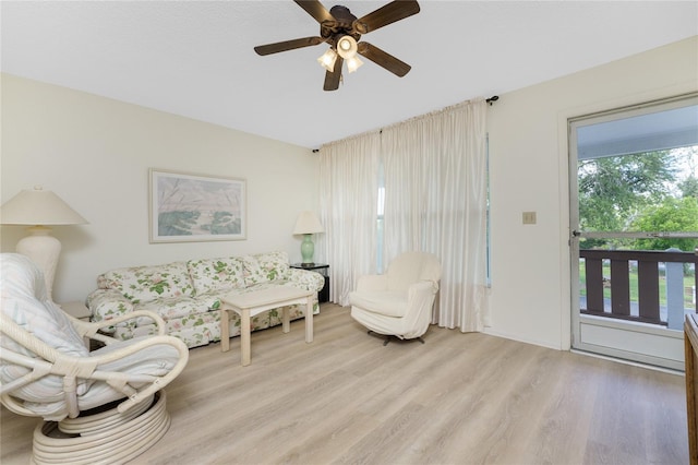 living room with plenty of natural light, light hardwood / wood-style flooring, and ceiling fan