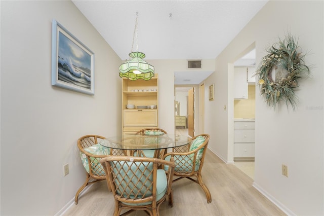 3 Quails Run Blvd Unit 8, Englewood, FL 34223 - dining room with baseboards, visible vents, and light wood finished floors