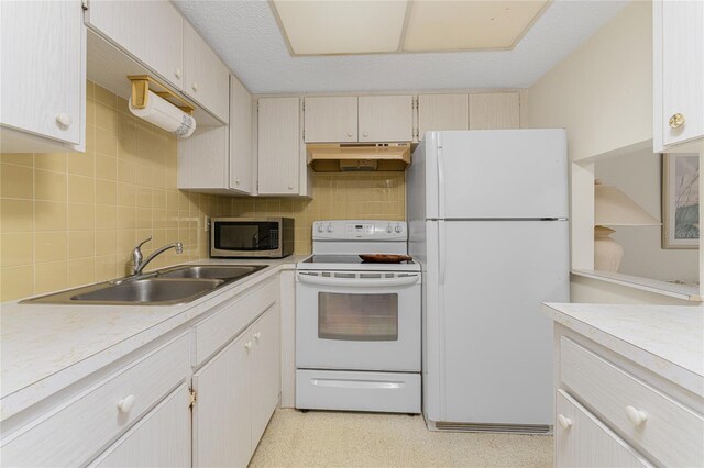 3 Quails Run Blvd Unit 8, Englewood, FL 34223 - kitchen with a sink, white appliances, light countertops, and under cabinet range hood