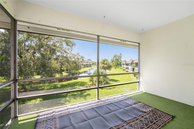 unfurnished sunroom featuring a water view