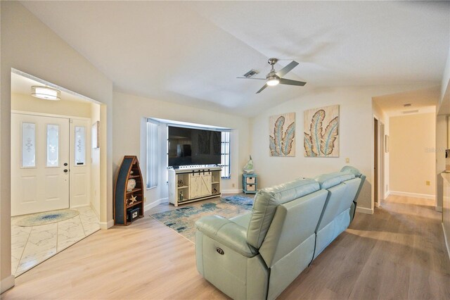 living room with lofted ceiling, ceiling fan, plenty of natural light, and light hardwood / wood-style floors