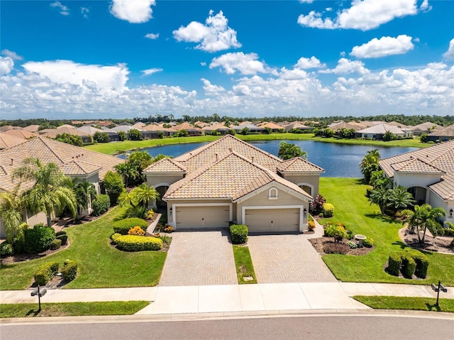 drone / aerial view with a water view and a residential view