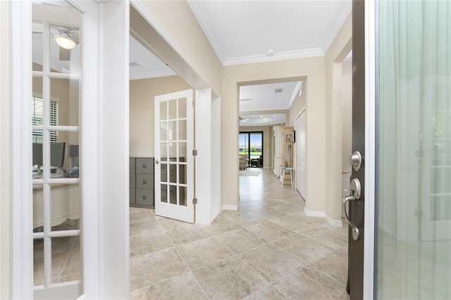 entrance foyer featuring baseboards, french doors, a healthy amount of sunlight, and crown molding