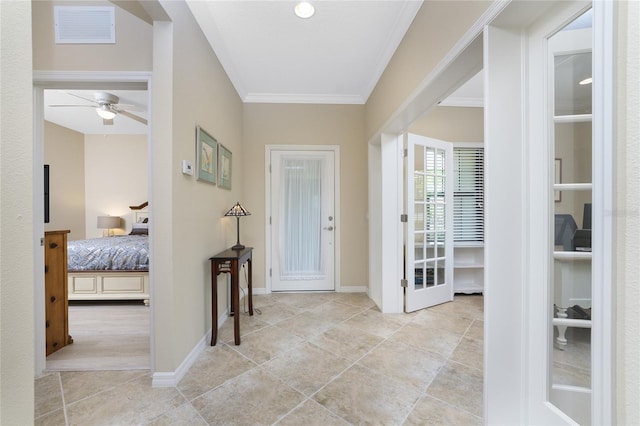 tiled foyer featuring a ceiling fan, visible vents, crown molding, and baseboards