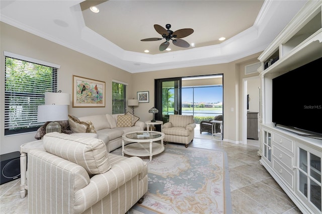 living room featuring light tile patterned floors, ornamental molding, a raised ceiling, and recessed lighting