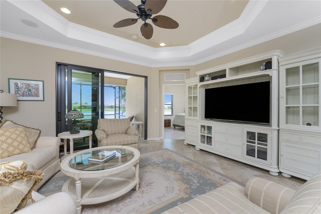 living room with recessed lighting, a ceiling fan, ornamental molding, a tray ceiling, and light tile patterned flooring