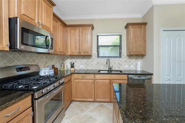 kitchen featuring dark stone countertops, stainless steel appliances, sink, light tile patterned flooring, and ornamental molding