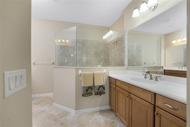 bathroom with tiled shower, tile patterned flooring, and vanity