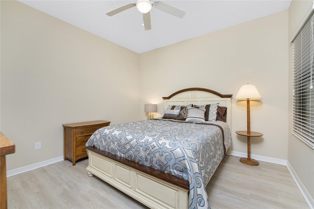 bedroom with light wood finished floors, ceiling fan, and baseboards