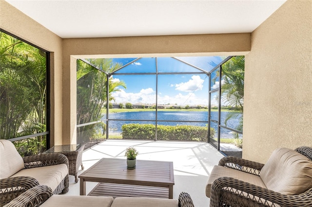 sunroom featuring a water view