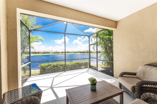 sunroom featuring a water view