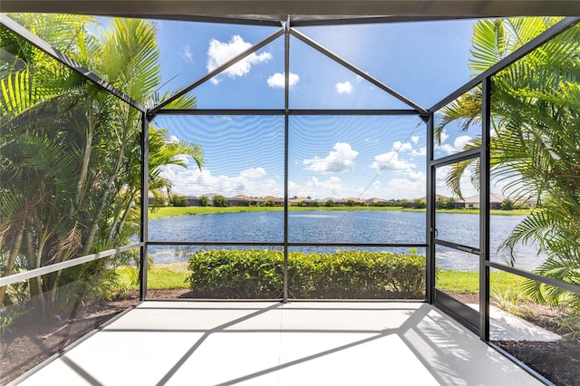 unfurnished sunroom with a water view