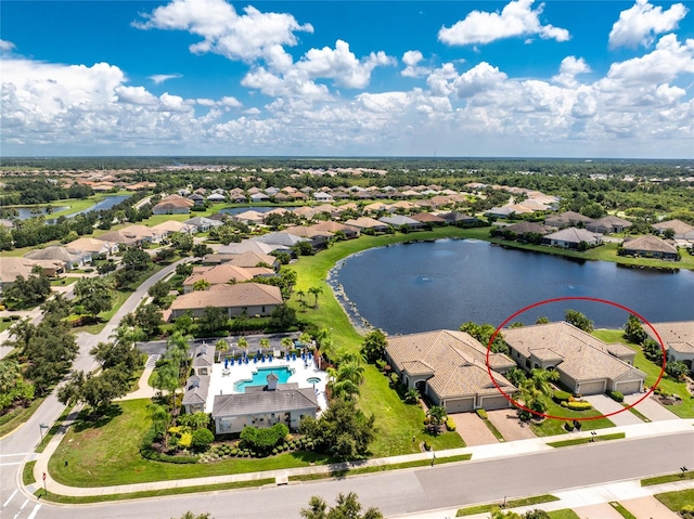 birds eye view of property with a water view