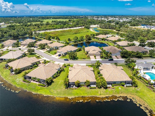 birds eye view of property featuring a water view and a residential view