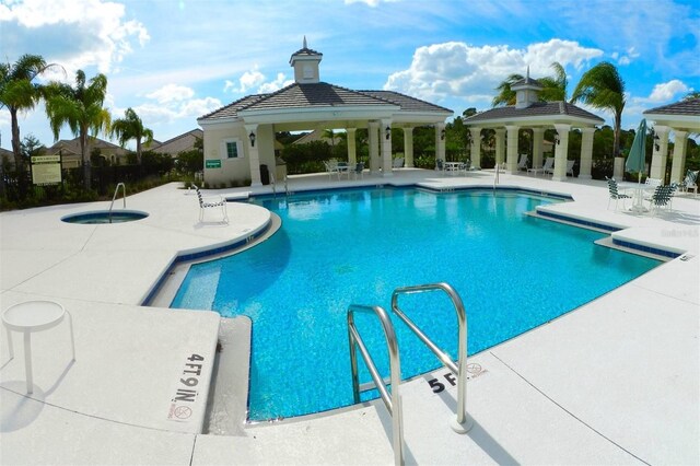 view of swimming pool featuring a patio and a gazebo