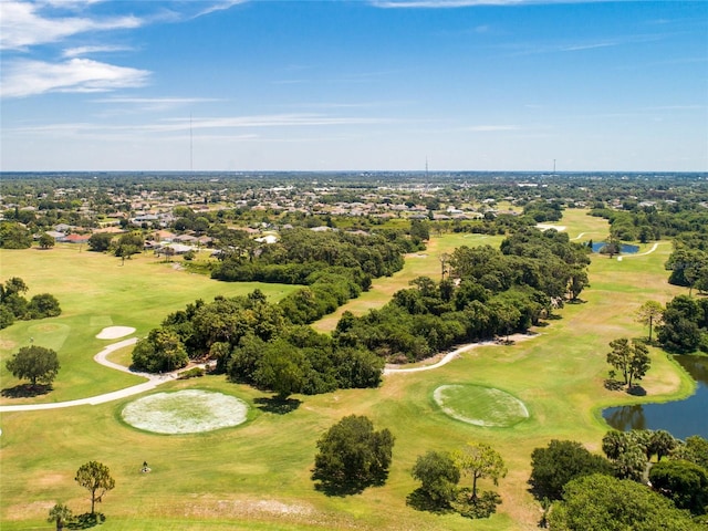 drone / aerial view featuring view of golf course and a water view