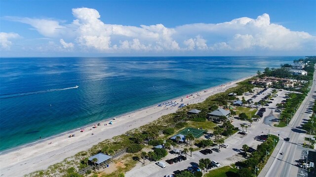 birds eye view of property featuring a beach view and a water view