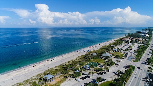 drone / aerial view with a beach view and a water view