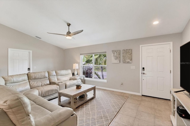 living room with ceiling fan, light tile patterned floors, and vaulted ceiling