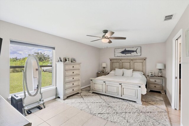 tiled bedroom with ceiling fan