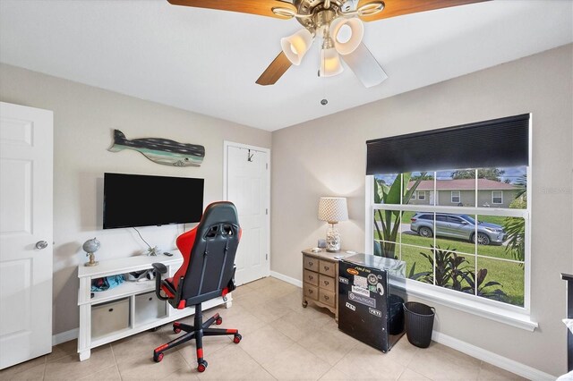 tiled home office featuring ceiling fan and a healthy amount of sunlight