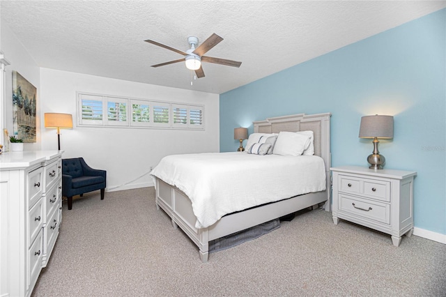 carpeted bedroom with a textured ceiling and ceiling fan