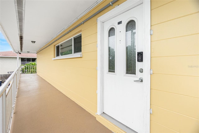 view of exterior entry featuring a balcony