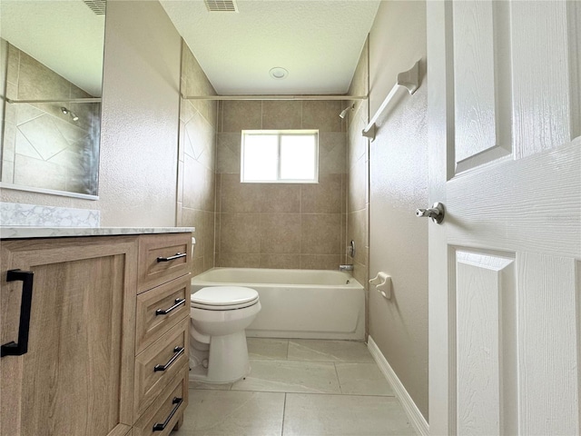 full bathroom featuring tile patterned flooring, vanity, a textured ceiling, tiled shower / bath, and toilet