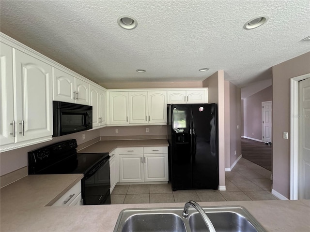 kitchen with white cabinetry, light tile patterned flooring, sink, and black appliances