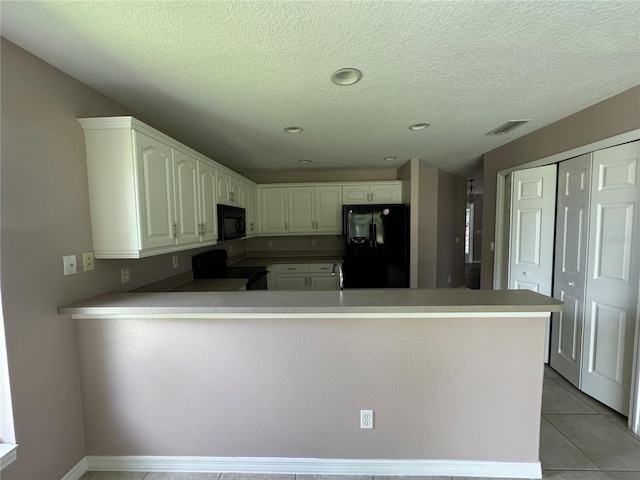 kitchen featuring white cabinetry, black appliances, a textured ceiling, light tile patterned flooring, and kitchen peninsula