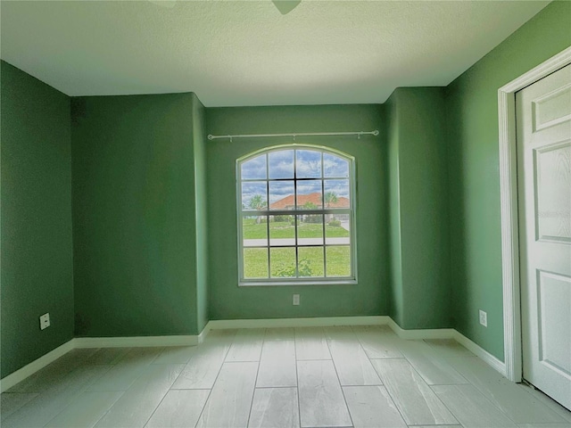 spare room featuring a textured ceiling