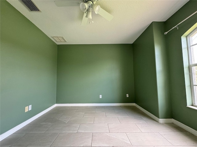 unfurnished room featuring light tile patterned floors and ceiling fan