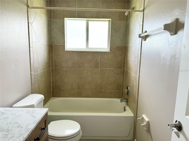 full bathroom with vanity, toilet, and tiled shower / bath combo