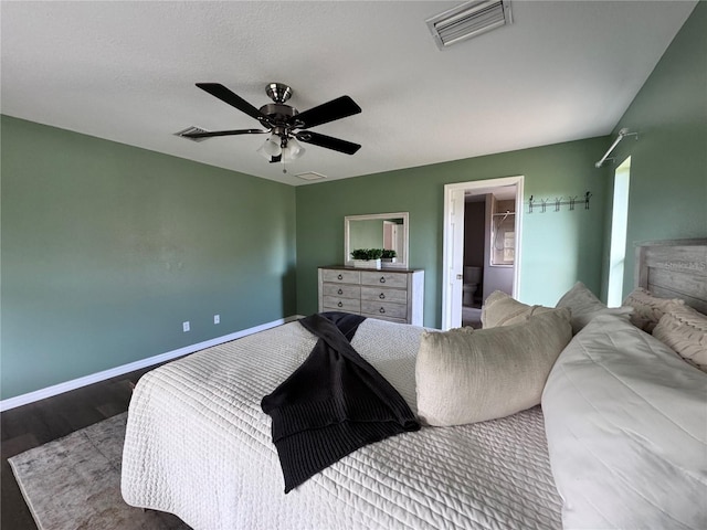 bedroom featuring ceiling fan, dark hardwood / wood-style floors, and a textured ceiling