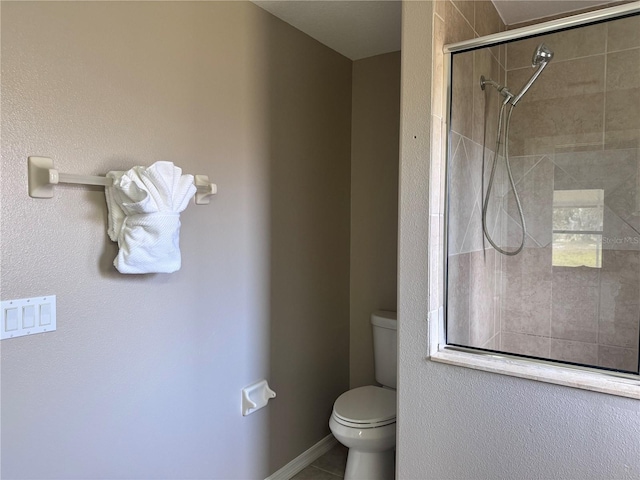 bathroom with walk in shower, tile patterned floors, and toilet