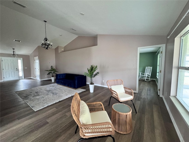 interior space with dark hardwood / wood-style flooring, a notable chandelier, and lofted ceiling