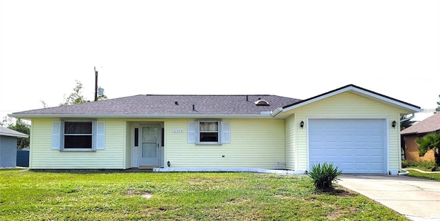 ranch-style house featuring a front yard and a garage