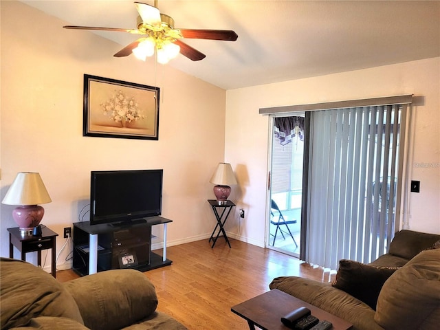 living room with lofted ceiling, ceiling fan, and light hardwood / wood-style floors