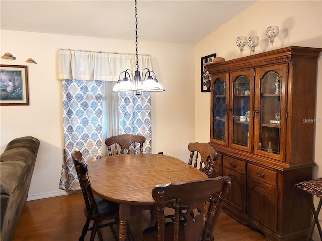 dining space featuring dark hardwood / wood-style floors and a notable chandelier