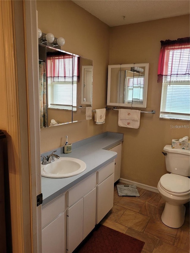 bathroom featuring toilet and vanity