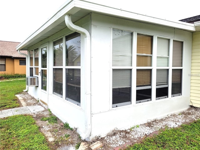 view of side of home with a sunroom