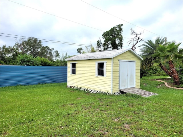 view of outbuilding featuring a yard