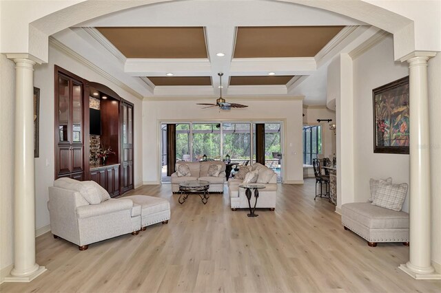 living room with light wood-type flooring, coffered ceiling, decorative columns, and ceiling fan