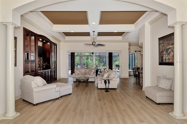 living room featuring light wood finished floors, coffered ceiling, a ceiling fan, and ornate columns