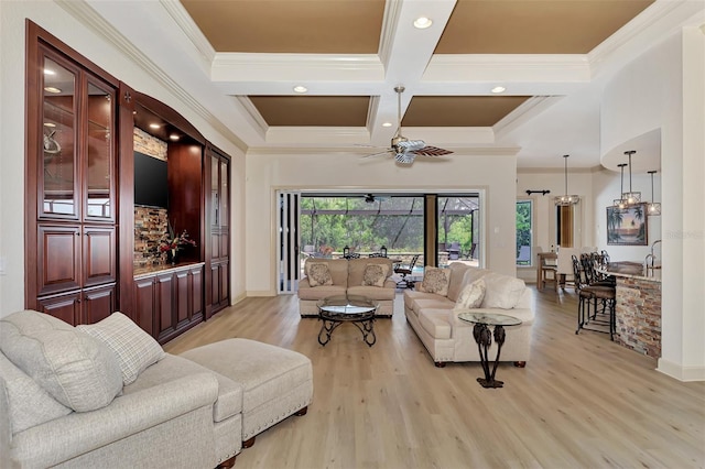 living room with coffered ceiling, beam ceiling, crown molding, ceiling fan, and light wood-type flooring