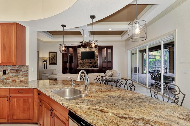 kitchen featuring ornamental molding, pendant lighting, coffered ceiling, and sink