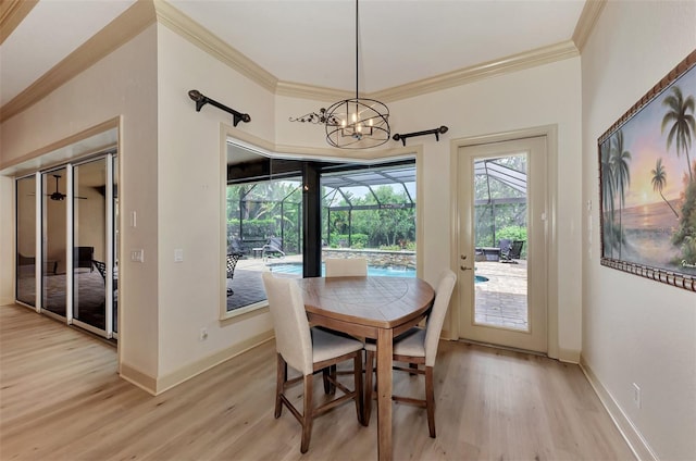 dining area featuring light wood-type flooring, an inviting chandelier, and ornamental molding